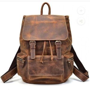 Genuine leather 14 inch backpack. Distressed look. Drawstring top and padded.